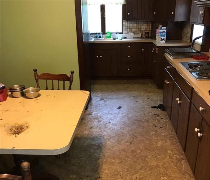 kitchen with debris and garbage throughout on the ground, table, sink