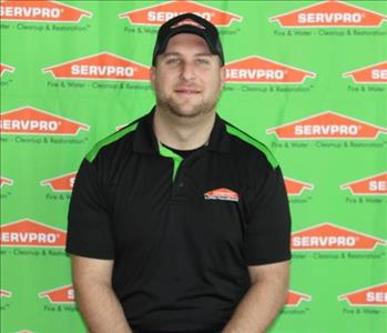 image of male employee standing in front of SERVPRO backdrop